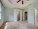 A large bedroom featuring a tray ceiling, walk-in closets, and an ensuite bathroom at 1273 Jonah Dr, North Port, FL 34289
