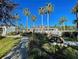 Beautiful clubhouse exterior with lush landscaping, pathway, and inviting picnic area for community enjoyment at 1273 Jonah Dr, North Port, FL 34289