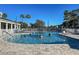 Sparkling community pool with residents enjoying a refreshing swim under a sunny, clear sky at 1273 Jonah Dr, North Port, FL 34289