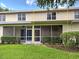 Back exterior elevation of the home featuring a screened-in porch and well-maintained landscaping at 1273 Jonah Dr, North Port, FL 34289