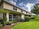 Back exterior elevation of the home featuring a screened-in porch and well-maintained landscaping at 1273 Jonah Dr, North Port, FL 34289