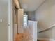 Hallway with neutral walls and carpet flooring leading to a bedroom with natural light at 1273 Jonah Dr, North Port, FL 34289