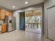 A view of the kitchen and stainless steel refrigerator with sliding doors to the outdoor patio at 1273 Jonah Dr, North Port, FL 34289