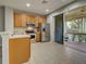 A spacious kitchen features stainless steel appliances and sliding door to screened patio at 1273 Jonah Dr, North Port, FL 34289