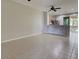 Spacious living room with tiled floors, ceiling fan and access to a screened porch at 1273 Jonah Dr, North Port, FL 34289