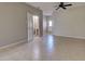 Living room with tile flooring leading to a bathroom with a pedestal sink at 1273 Jonah Dr, North Port, FL 34289