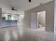 Open-concept living area with tile flooring, a ceiling fan, and access to the kitchen at 1273 Jonah Dr, North Port, FL 34289