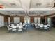 Spacious meeting room features tables, chairs, chandelier, and ample lighting for gatherings and events at 1273 Jonah Dr, North Port, FL 34289