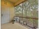 Screened in porch with bamboo shades and view of lush greenery at 1273 Jonah Dr, North Port, FL 34289