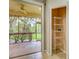 A screened-in porch with a view of the lush backyard and a storage closet at 1273 Jonah Dr, North Port, FL 34289