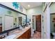 This bathroom features double sinks, granite countertops, and decorative wall art at 1318 Red Oak Ln, Port Charlotte, FL 33948