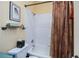 Bathroom with a shower-tub combo, white tiling, and a stylish shower curtain at 1318 Red Oak Ln, Port Charlotte, FL 33948