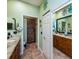 Open bathroom with double sinks, tiled floors, and walk-in shower at 1318 Red Oak Ln, Port Charlotte, FL 33948