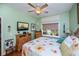 This bedroom features a ceiling fan, a window, and hardwood floors at 1318 Red Oak Ln, Port Charlotte, FL 33948