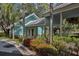 Charming exterior featuring a covered entrance, tropical landscaping, and covered walkway at 1318 Red Oak Ln, Port Charlotte, FL 33948