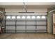 Garage showcasing a white garage door with translucent windows, along with the overhead door mechanism at 1318 Red Oak Ln, Port Charlotte, FL 33948