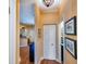 Hallway view leading to a kitchen with stainless steel appliances and an entryway with a white front door at 1318 Red Oak Ln, Port Charlotte, FL 33948