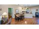 Cozy living area showcasing hardwood floors and connecting seamlessly to the kitchen at 1318 Red Oak Ln, Port Charlotte, FL 33948
