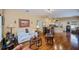Open-concept living room with hardwood floors, flowing into the dining and kitchen areas at 1318 Red Oak Ln, Port Charlotte, FL 33948