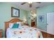 This bedroom features an ensuite bathroom, hardwood floors, and bright green walls at 1318 Red Oak Ln, Port Charlotte, FL 33948