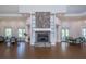 Large meeting space with stone fireplace, wood floors, and seating areas at 1318 Red Oak Ln, Port Charlotte, FL 33948