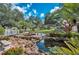 Beautiful pond with rock features, tropical plants and lush landscaping at 1318 Red Oak Ln, Port Charlotte, FL 33948