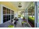 Inviting screened porch offering a relaxing seating area with views of the lush landscaping at 1318 Red Oak Ln, Port Charlotte, FL 33948