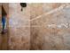 Close-up of the tiled shower showcasing its decorative trim, dark shower head, and shampoo shelf at 1318 Red Oak Ln, Port Charlotte, FL 33948