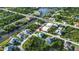 Aerial view of a home situated near a canal, surrounded by lush greenery and neighboring houses at 13406 Chenille Dr, Port Charlotte, FL 33981