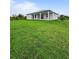 Wide shot of a sprawling backyard and covered patio attached to the home at 13406 Chenille Dr, Port Charlotte, FL 33981