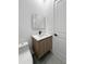 Modern bathroom featuring a floating vanity, new toilet, and decorative mirror at 13406 Chenille Dr, Port Charlotte, FL 33981