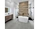 Spacious bathroom featuring modern freestanding tub and dual walk-in showers, enhanced by stylish wood accents at 13406 Chenille Dr, Port Charlotte, FL 33981