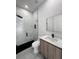 Modern bathroom with glass shower, floating vanity, and marble-look shower walls at 13406 Chenille Dr, Port Charlotte, FL 33981