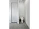 Clean white bathroom featuring an enclosed toilet area and double door access at 13406 Chenille Dr, Port Charlotte, FL 33981