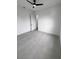 An empty bedroom has tile flooring and a ceiling fan at 13406 Chenille Dr, Port Charlotte, FL 33981