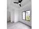 Clean bedroom featuring a ceiling fan, large window, and light gray flooring at 13406 Chenille Dr, Port Charlotte, FL 33981