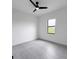 An empty bedroom has tile flooring, a ceiling fan, and a window at 13406 Chenille Dr, Port Charlotte, FL 33981