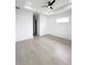 Bright, open bedroom with neutral tile flooring, modern ceiling fan and ample natural light at 13406 Chenille Dr, Port Charlotte, FL 33981
