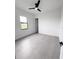 Bedroom with a window and gray floors, providing a bright and spacious feel at 13406 Chenille Dr, Port Charlotte, FL 33981