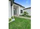 Inviting entryway with stylish landscaping and a modern front door, perfect for welcoming guests at 13406 Chenille Dr, Port Charlotte, FL 33981
