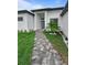 Beautiful home featuring a stone walkway leading to the front door and well-manicured landscaping at 13406 Chenille Dr, Port Charlotte, FL 33981