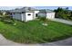 The spacious front yard of a modern home, showcasing the lush lawn and curb appeal at 13406 Chenille Dr, Port Charlotte, FL 33981