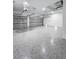 Two car garage featuring epoxy floors, white walls, and two garage door openers at 13406 Chenille Dr, Port Charlotte, FL 33981
