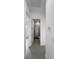 Hallway with a bathroom view, showcasing the clean, contemporary design throughout at 13406 Chenille Dr, Port Charlotte, FL 33981