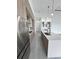 Modern kitchen with stainless steel appliances, an island, and sleek wood cabinets at 13406 Chenille Dr, Port Charlotte, FL 33981