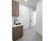 Minimalist laundry room featuring a sink, modern cabinet, and clean design at 13406 Chenille Dr, Port Charlotte, FL 33981