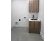Functional laundry room with modern sink, storage cabinet, and sleek fixtures at 13406 Chenille Dr, Port Charlotte, FL 33981