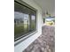 View from the outside looking into the house through a big window and overlooking the covered patio at 13406 Chenille Dr, Port Charlotte, FL 33981