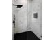 Modern shower showcasing marble-look tile and sleek, black fixtures and shower head at 13406 Chenille Dr, Port Charlotte, FL 33981
