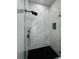 Glass enclosed shower with black fixtures and marble-look tile at 13406 Chenille Dr, Port Charlotte, FL 33981